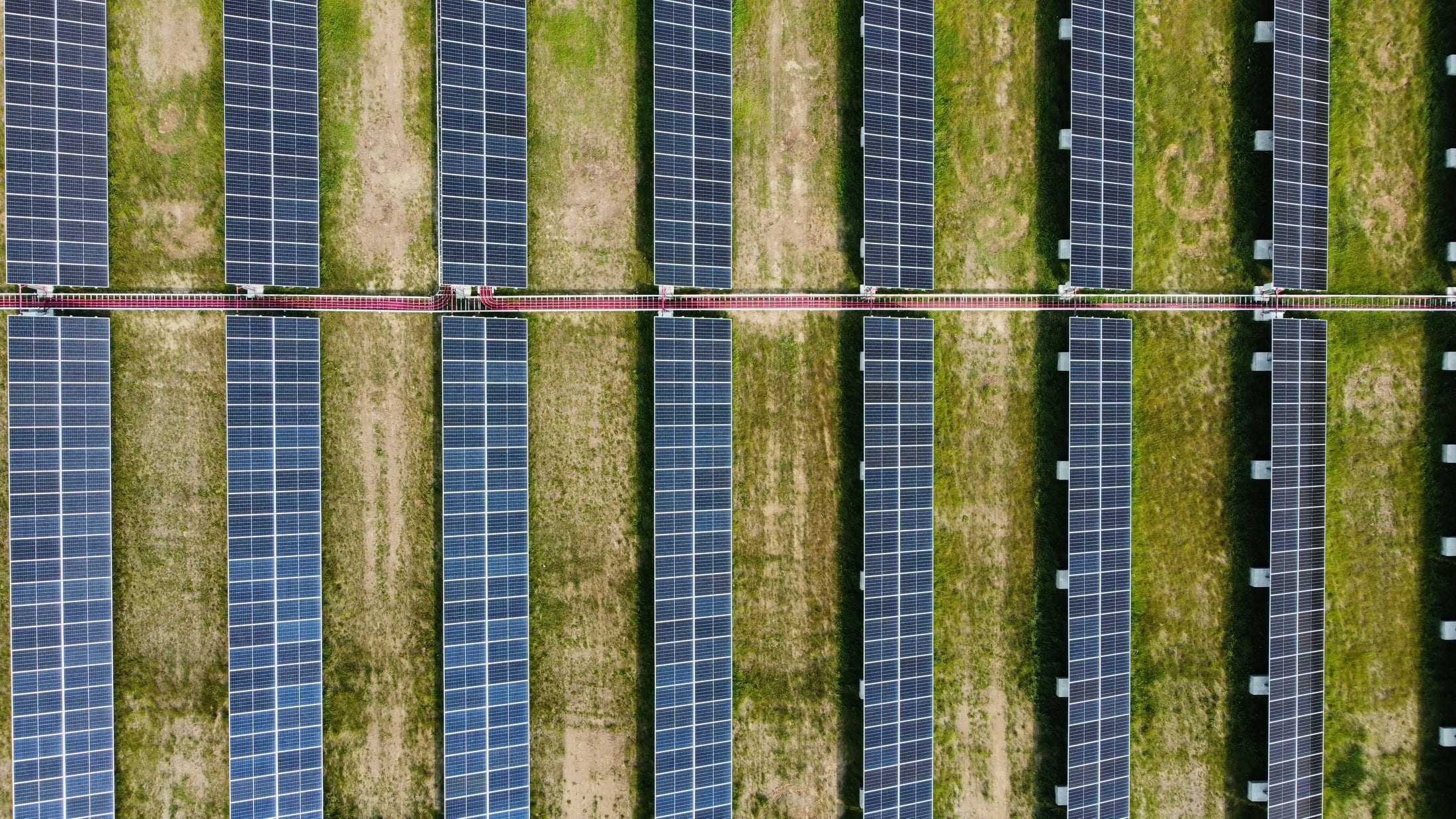 Luftaufnahme einer Photovoltaik-Freiflächenanlage in Reihenbauweise